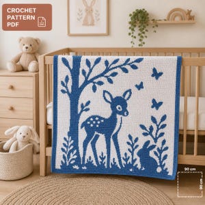 May include: A white and blue crochet baby blanket with a forest scene featuring a deer, butterflies, and a rabbit. The blanket is 35 inches square and is draped over a wooden crib. The text "CROCHET PATTERN PDF" is in the upper left corner.
