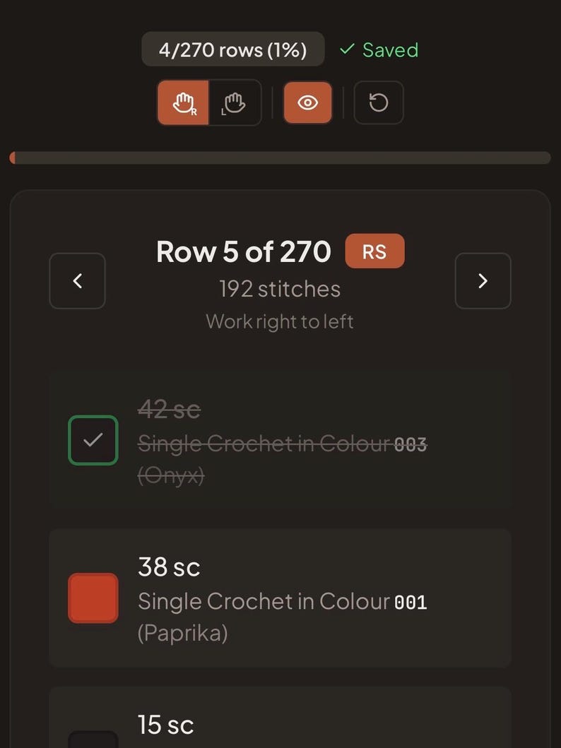 May include: A digital interface displaying crochet pattern instructions for Row 5 of 270, featuring 192 stitches. The screen shows 42 single crochet stitches in Onyx color 003 and 38 single crochet stitches in Paprika color 001 with text.