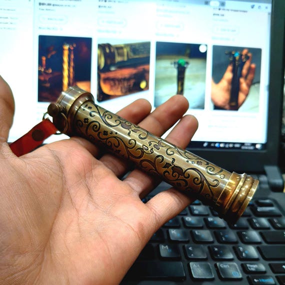 A fully functional antique-brass kaleidoscope with a real marble eyepiece and hand engraving — the kind of desk object that stops visitors mid-sentence.