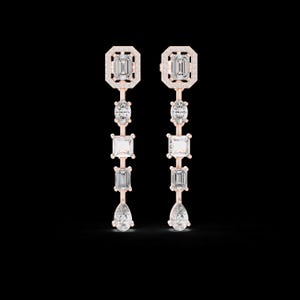 May include: A pair of rose gold earrings with multiple clear, sparkling gemstones. Each earring features a rectangular top, an oval stone, a square stone, a rectangular stone, and a pear-shaped stone, all set in a linear design.