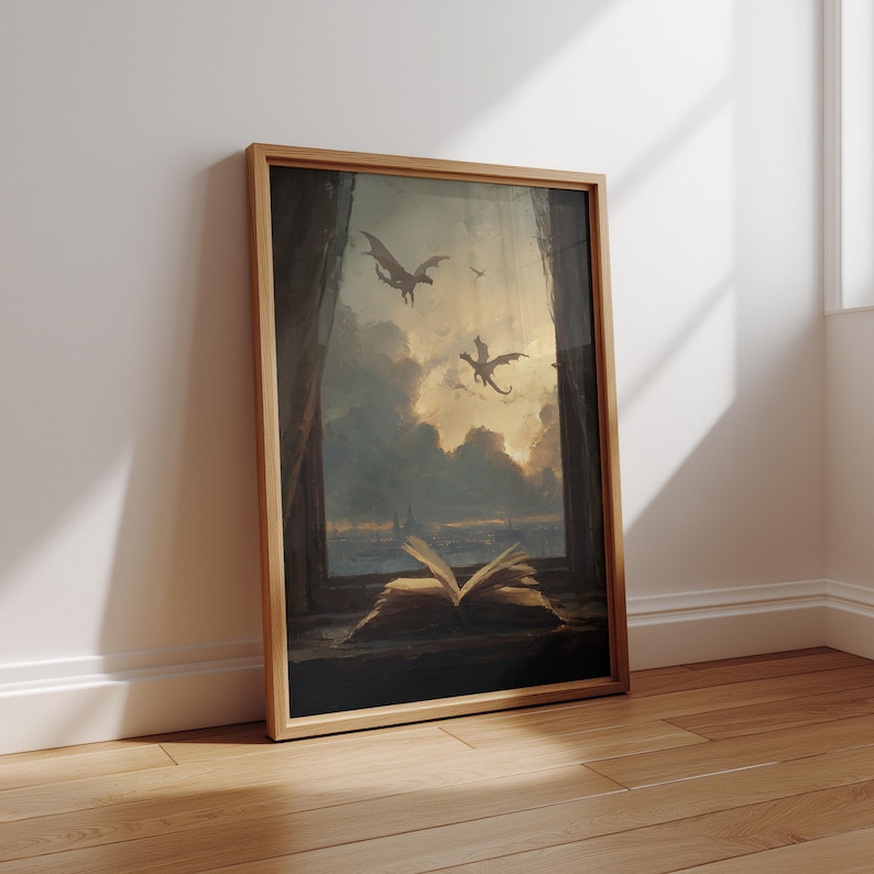 May include: A framed artwork depicts a fantasy scene with dragons soaring through a cloudy sky. An open book rests on a windowsill, with a view of the sky and dragons. The artwork is in a wooden frame.