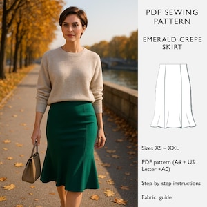 Może przedstawiać: Kobieta w beżowym swetrze i ciemnozielonej spódnicy, trzymająca brązową torebkę, idzie ścieżką wzdłuż drzew. Spódnica to wzór do szycia PDF o nazwie "Emerald Crepe Skirt" i jest dostępna w rozmiarach XS-XXL.