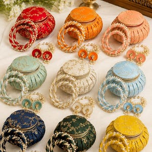 May include: An assortment of colorful jewelry sets, including round, lidded boxes and matching bangles and earrings. The sets are in various colors like red, orange, pink, blue, green, and yellow, with gold accents and pearl-like beads.
