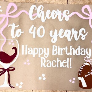 The image is a birthday card for someone's 40th birthday, with a wine glass, football, and a ribbon.