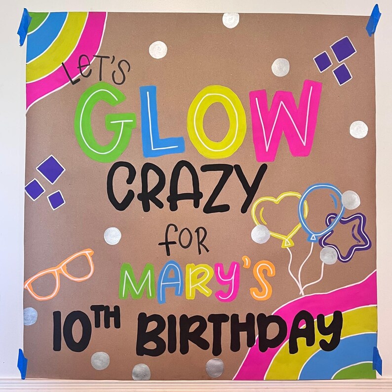 A colorful birthday sign with the text "Let's glow crazy for Mary's 10th birthday" written on it.