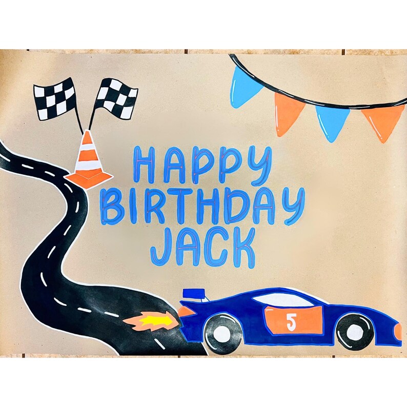 The image is a birthday banner for a child named Jack, featuring a race car, checkered flags, and a banner with the text "Happy Birthday Jack".
