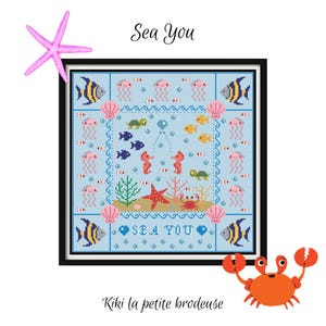 May include: A framed cross-stitch featuring an underwater scene with fish, seahorses, jellyfish, and a crab. The text "Sea You" is included in the design. A pink starfish and an orange crab are also present. The design is on a light blue background.