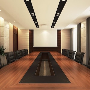 May include: A modern conference room with a long wooden table and black leather chairs. The room features a white screen, recessed lighting, and large windows with gray curtains. The walls are a mix of wood paneling and textured stone.