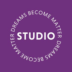 May include: A purple background with the white word "STUDIO" in the centre. A white circular text surrounds the word, reading "DREAMS BECOME MATTER" at the top and "MATTER DREAMS BECOME" at the bottom.