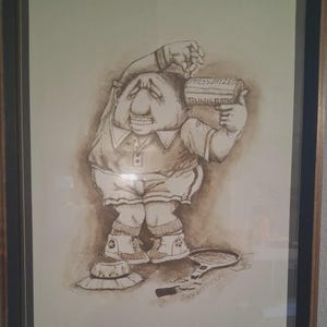 May include: A framed sepia-toned cartoon illustration of a distressed figure holding a cylinder labeled "PRESSURIZED TENNIS BALLS." A broken tennis racket and a hat are on the ground. Signed "GARY PATTERSON".