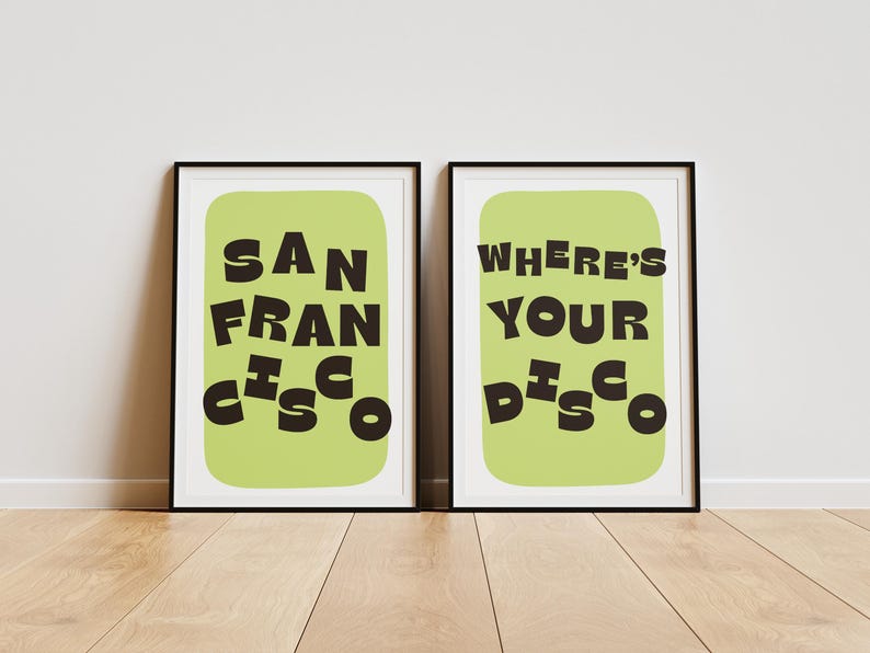 May include: Two framed art prints with black frames. One print says "SAN FRANCISCO" in black letters on a light green background. The other print says "WHERE'S YOUR DISCO" in black letters on a light green background.