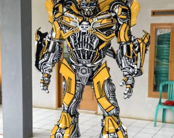 May include: A full-body costume of the Transformers character Bumblebee. The costume is primarily yellow with black and silver accents, featuring intricate mechanical details. The robot stands upright, showcasing its detailed design.