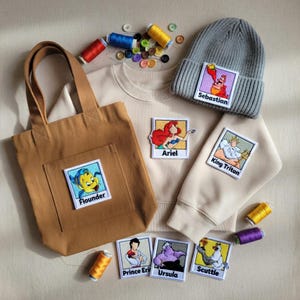 May include: A white ceramic mug with a black handle and the text "But First, Coffee" in a black, bold font. The mug is sitting on a white surface. The mug is approximately 4 inches tall.