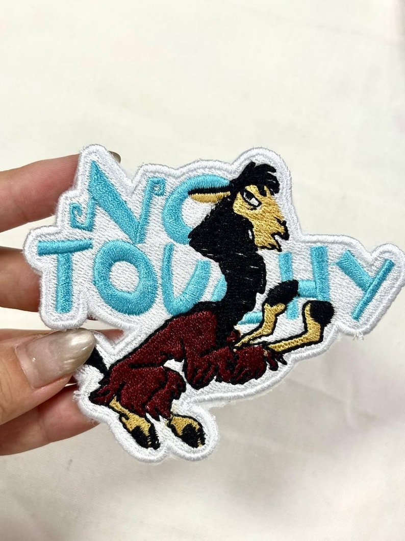 May include: Embroidered patch featuring a cartoon llama in a dynamic pose. The llama is primarily burgundy with black and yellow accents. The patch has the words "NO TOUCHY" in light blue letters with a white border. This patch is suitable for jackets, bags, or other fabric items.