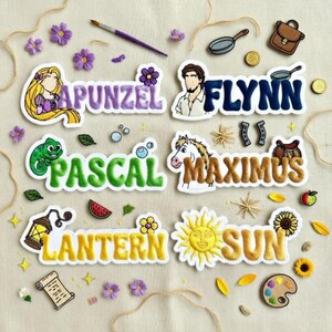 May include: Embroidered patches featuring characters and elements from a fairy tale. The patches include the names "Rapunzel", "Flynn", "Pascal", "Maximus", "Lantern", and "Sun", along with related illustrations and decorative elements.