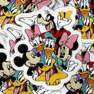 May include: Embroidered patches featuring various Disney characters, including Mickey Mouse, Minnie Mouse, Donald Duck, Daisy Duck, Goofy, and Pluto. The patches have a white border and are in vibrant colors like yellow, red, pink, and black.
