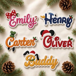 May include: Five embroidered name patches featuring festive designs: Emily with a red bow, Henry with a sailor hat, Carter with a green hat, Oliver with mouse ears and a Santa hat, and Buddy with dog ears and a Santa hat.