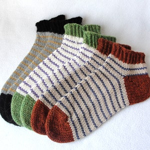 May include: Three pairs of striped ankle socks in different colors. The socks are made of a soft, knitted fabric. The socks are a great addition to any wardrobe.