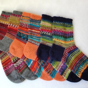 May include: Five pairs of colorful striped knitted socks. The socks are made with a variety of colors, including orange, red, blue, green, and yellow. The socks are all different lengths, but they are all made with the same type of yarn.
