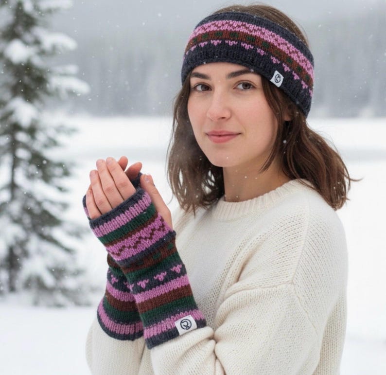May include: A knitted headband and fingerless gloves set. The headband and gloves feature a pattern of pink, green, and brown stripes on a dark gray background. The gloves have a small white tag with a logo.