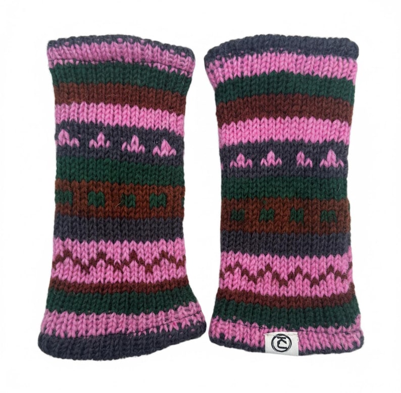 May include: A pair of knitted arm warmers in shades of pink, green, brown, and gray. The arm warmers feature a striped pattern with geometric and zig-zag designs. The cuffs are a darker gray color. A small white tag with a logo is visible on one of the arm warmers.