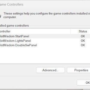 May include: A screenshot of a "Game Controllers" window. The window displays a list of installed game controllers, including "PilotWisdom StartPanel," "PilotWisdom LightsPanel," and "PilotWisdom DoubleSwPanel." The status of each controller is "OK."