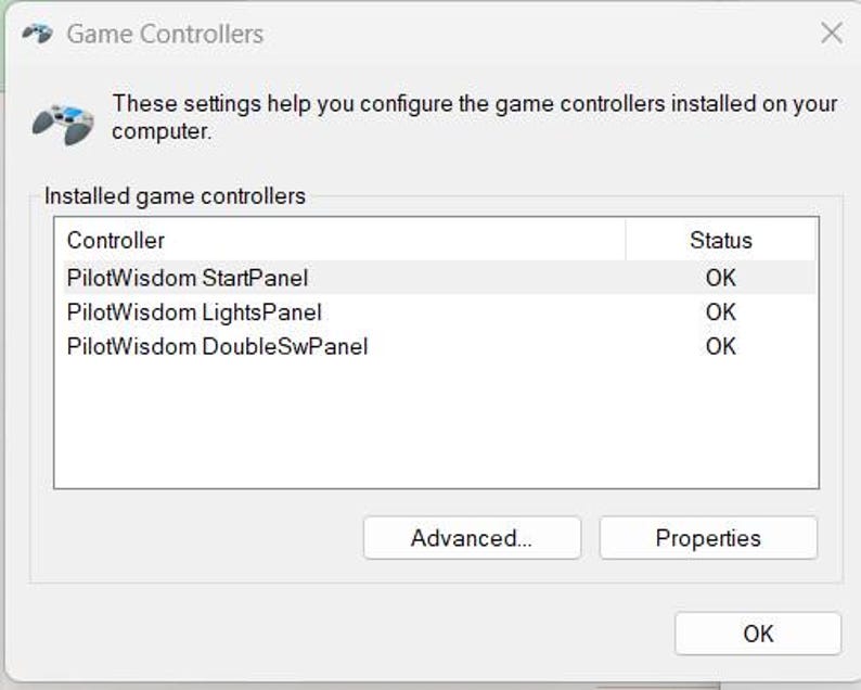 May include: A screenshot of a "Game Controllers" window. The window displays a list of installed game controllers, including "PilotWisdom StartPanel," "PilotWisdom LightsPanel," and "PilotWisdom DoubleSwPanel." The status of each controller is "OK."