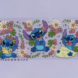 May include: A sticker sheet featuring three blue cartoon characters with large ears, each adorned with flowers. The characters are surrounded by floral and leaf designs in pink, white, and green. The text "WONDERWRAPZ" is printed at the bottom.