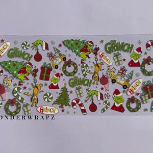 May include: A sheet of Christmas-themed stickers featuring the Grinch. The stickers include images of the Grinch, Christmas trees, candy canes, gifts, and wreaths. The word "Grinch" is written on several stickers. The brand name "WONDERWRAPZ" is at the bottom.