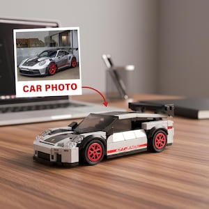 May include: A white, black, and red toy car model with the text "GT3 RS" on the side. The car has red wheels and a black spoiler. A photo labeled "CAR PHOTO" is next to the toy car.