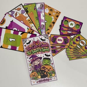 May include: A collection of printed Halloween-themed paper money and savings trackers. The central card features a cartoon witch, a Frankenstein monster, a pumpkin, and a black cat with the text Too Cute to Spook, Too Smart to Spend and @PilarSavings.