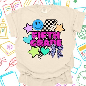 Peut inclure: T-shirt crème de cinquième année avec un graphisme coloré. Le motif comprend un smiley, des étoiles, des cœurs, un motif à carreaux et un nœud léopard. Les mots "FIFTH GRADE" sont en rose vif.