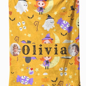 May include: A yellow Halloween-themed blanket with a repeating pattern of ghosts, witches, bats, skulls, and candy. The name "Olivia" is displayed in large letters. Two photos of a child are also included.
