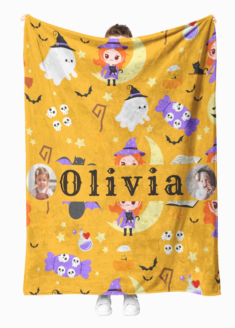 May include: A yellow Halloween-themed blanket with a repeating pattern of ghosts, witches, bats, skulls, and candy. The name "Olivia" is displayed in large letters. Two photos of a child are also included.