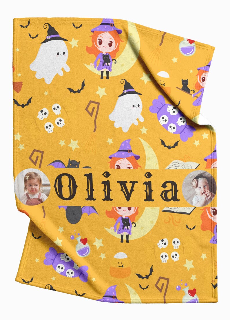 May include: Mustard yellow Halloween-themed blanket with cartoon witches, ghosts, bats, and skulls. The name "Olivia" is printed in large black letters. Includes two circular photo inserts.