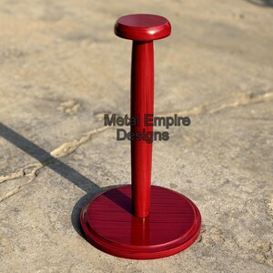 May include: A red wooden helmet stand with a round base and top, and a central pole. The stand has the text "Metal Empire Designs" on the pole. The stand is designed to hold a helmet.