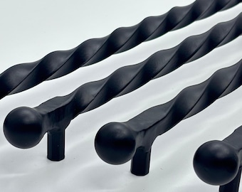 May include: Four black, twisted metal cabinet pulls with a matte finish. Each pull has a rounded end and a cylindrical base. The pulls are arranged diagonally, showcasing their decorative, textured design. Ideal for adding a touch of elegance to furniture.