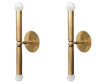 Par de apliques de pared cilíndricos de mediados de siglo con acabado en latón crudo, estilo italiano. Lámparas de dormitorio y tocador.