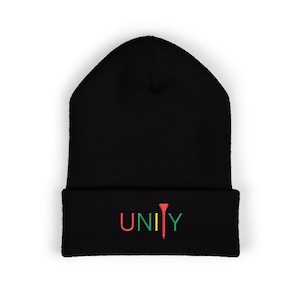 May include: Black beanie hat with the word "UNITY" embroidered in red, green, and yellow. The "I" in UNITY is designed as a golf tee. The hat is made of a soft, knitted material.
