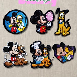 May include: A handmade, ceramic mug with a speckled, cream-colored glaze. The mug features a wide, rounded body and a sturdy handle. The interior is a darker, earthy tone. Perfect for coffee or tea.