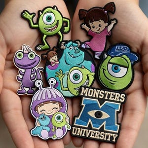 Puede incluir: Colección de parches bordados con personajes de las películas de animación "Monstruos, S.A." y "Monstruos University". Los parches incluyen a Mike Wazowski, Sulley, Boo y el logo de Monsters University. Los parches son coloridos y detallados.