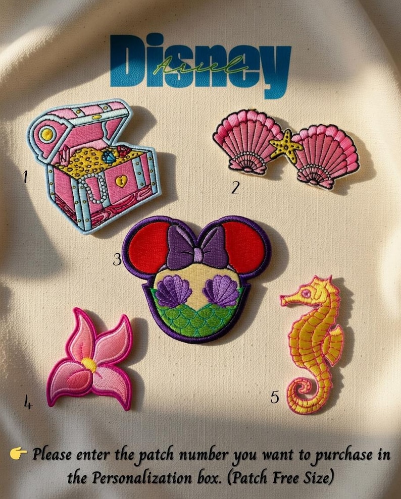 May include: Embroidered patches featuring Disney-themed designs. Includes a pink treasure chest, two pink seashells with a starfish, a Minnie Mouse-inspired design with Ariel's tail, a pink flower, and a yellow seahorse. The word "Disney" is above the patches.