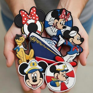 May include: A selection of colourful Disney character patches featuring Mickey Mouse, Minnie Mouse, and Pluto. Designs include nautical themes, life preservers, and a cruise ship. The patches are embroidered with vibrant colours and detailed artwork.