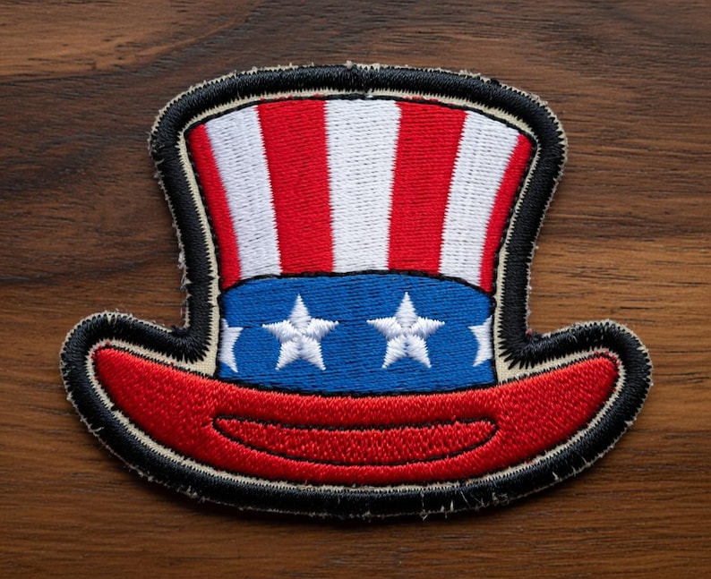 May include: Embroidered patch featuring a patriotic Uncle Sam hat design. The hat has red and white stripes, a blue band with white stars, and a red brim. The patch is outlined in black.