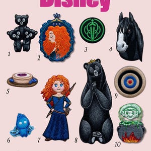 Op de afbeelding: Een verzameling Disney-thema geborduurde patches. Ontwerpen omvatten een zwarte berenfamilie, een portret van een vrouw met rood haar, een groen embleem, een zwarte paardenkop, een dessert, een blauw wezen, een meisje in een blauwe jurk, een zwarte beer, een doel en een ketel. Het woord "Disney" staat bovenaan.