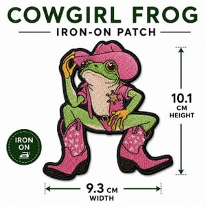 May include: An embroidered iron-on patch featuring a green frog wearing a pink cowboy hat, a pink shirt with a star badge, and pink cowboy boots with white heart patterns. The patch measures 10.1 cm in height and 9.3 cm in width, labelled Cowgirl Frog.