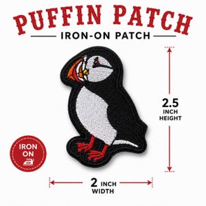May include: An embroidered iron-on patch featuring a puffin with black, white, and orange details. The text reads Puffin Patch Iron-On Patch. The patch measures 6.35 cm in height and 5.08 cm in width, with an iron-on icon in a red circle.
