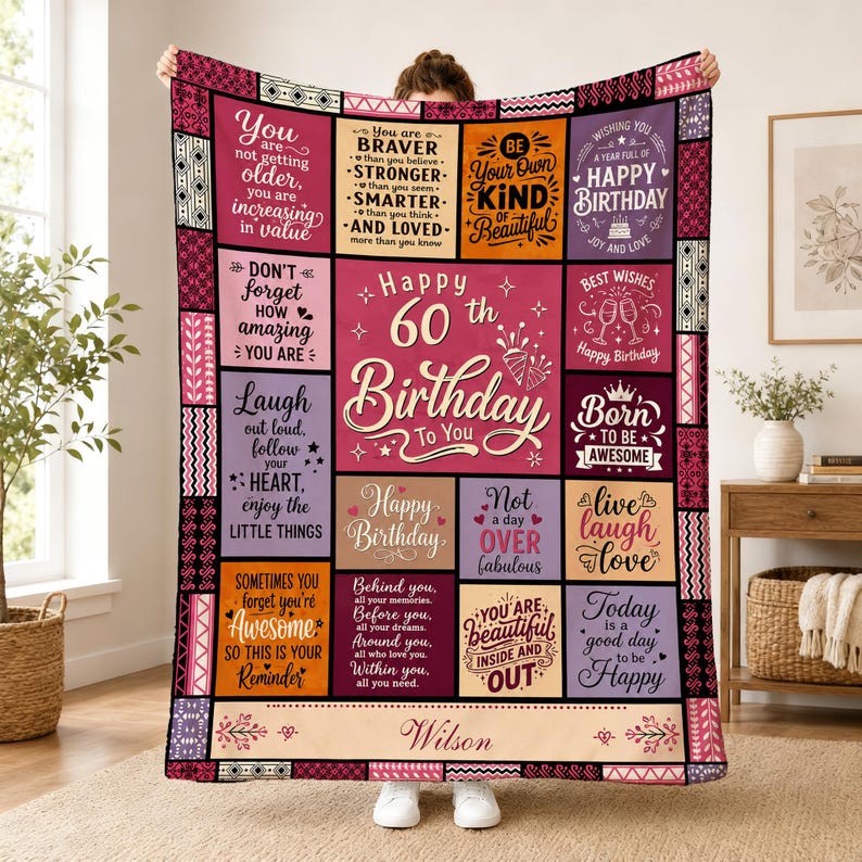 May include: A rectangular throw blanket featuring a patchwork design with various inspirational quotes and birthday messages in shades of pink, purple, orange, and black. The center panel displays the text Happy 60th Birthday to You and Wilson.