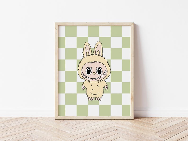 May include: A framed print featuring a cartoon character in a bunny costume. The character has a menacing grin and is set against a green and white checkered background. The artwork is in a wooden frame and is displayed on a white wall.