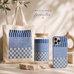 May include: A canvas tote bag, a glass tumbler with a bamboo lid and straw, and a smartphone case, all featuring a matching blue and white pattern of vertical stripes, horizontal stripes, and a checkerboard design with the text MATCH YOUR favorites.
